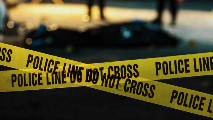 Police tape marking a crime scene at night