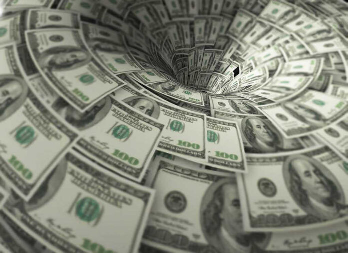 760572118 Hundred dollar bills swirling into a financial vortex