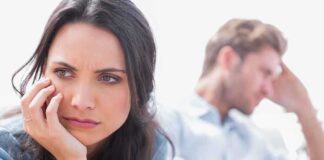 A woman looking concerned while a man appears distressed in the background