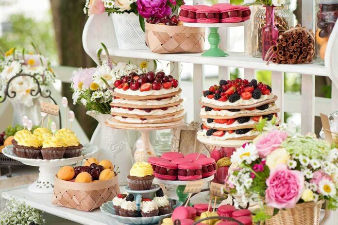 A beautifully arranged dessert table featuring various pastries and fruits