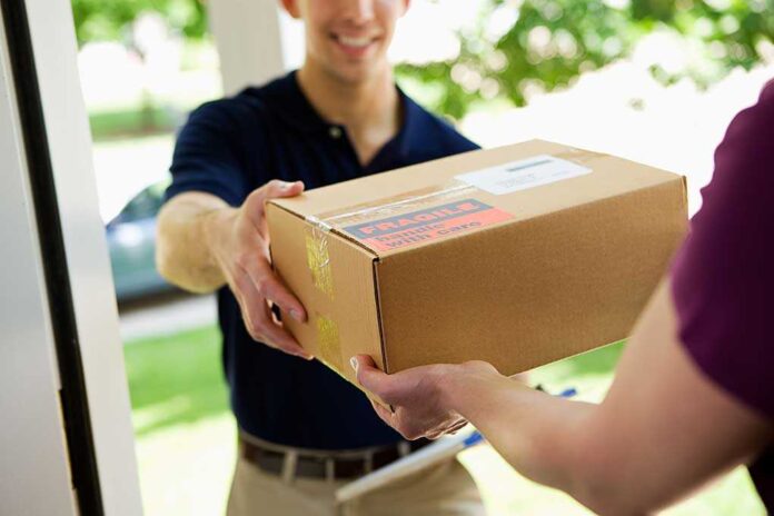 A delivery person handing a package to a customer at their doorstep