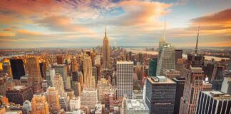 Aerial view of New York City skyline during sunset with skyscrapers and clouds