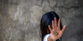 Person with an X on their palm