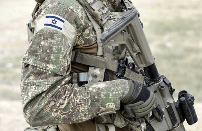 Soldier in camouflage gear with Israeli flag patch