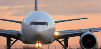Airplane on runway during sunset