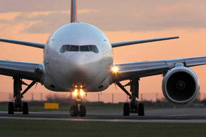 555148006 Airplane on runway during sunset