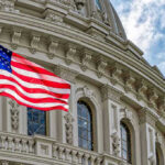 US flag in front of Capitol building