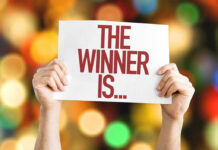 Bomb Suit Hero DESTROYS Previous Record Hands holding a sign reading The Winner Is...