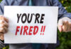 Cop Tackles Knife Criminal – Gets FIRED Instead Person holding YOURE FIRED sign.