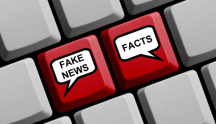 585719204 Keyboard keys labeled Fake News and Facts.