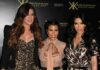 Kim Kardashian SHOCKS Wall Street Skeptics Three Kardashian sisters posing together at a fashion event