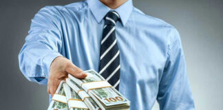 Person handing over a stack of money.