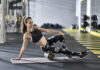 Woman using foam roller in gym setting