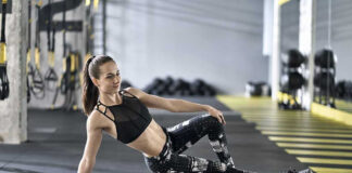 Woman using foam roller in gym setting