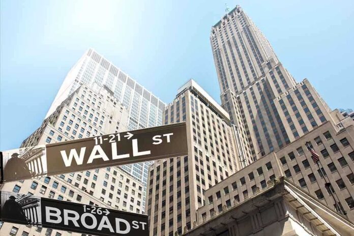 shutterstock_156562427.jpg Street signs for Wall Street and Broad Street with skyscrapers in the background