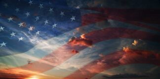 A sunset with an overlay of the American flag and dramatic clouds