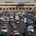 Holiday Rant Ignites Chaos A crowded parking lot filled with cars near a border crossing