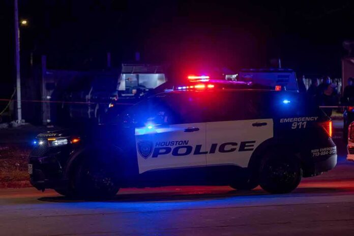 Houston police vehicle with emergency lights activated at night