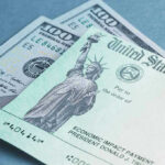 $2,000 Stimulus Mystery: Will It Ever Happen? $100 bill and U.S. Treasury check.