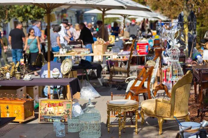 A bustling flea market with various antique items and furniture for sale
