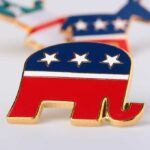 A red, white, and blue elephant pin representing the Republican Party