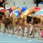 Female athletes preparing to start a race in track and field