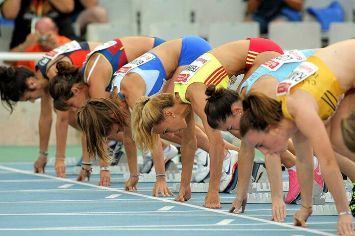 shutterstock_83877250.jpg Female athletes preparing to start a race in track and field