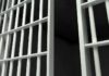 Close-up view of metal prison bars in a dark environment