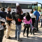 650 ICE Arrests Shock West Virginia Families and children waiting in line near a bus