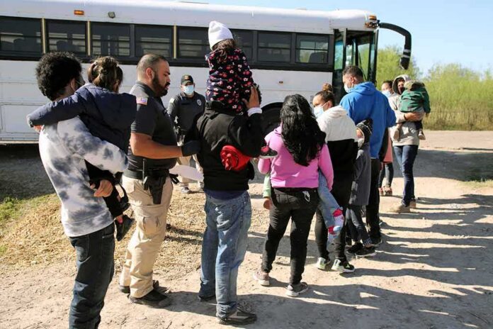 Families and children waiting in line near a bus