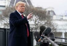 Donald Trump gesturing while speaking to the press outside