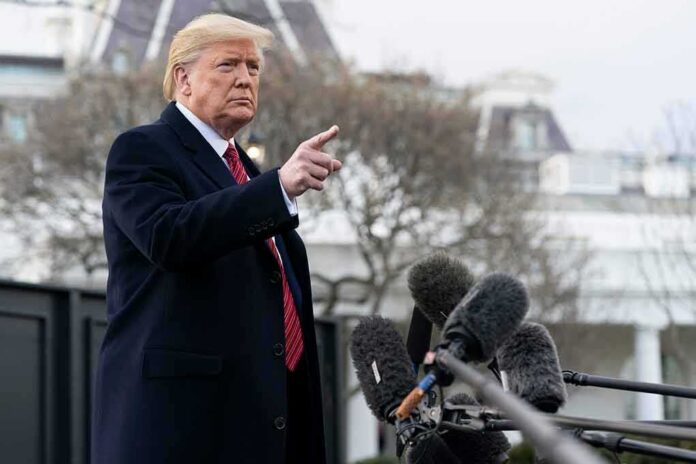 shutterstock_2600426001.jpg Donald Trump gesturing while speaking to the press outside