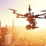 Mystery Object Strikes United Flight – Was It A Drone? A drone flying over a city skyline during sunset