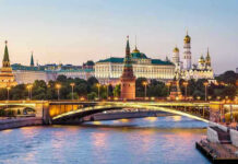 Kremlin’s Mixed Messages! Is Peace a Mirage? Illuminated bridge and Kremlin complex across river at twilight.