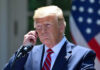 Trump Targets Cartels: Shocking Strategy! Man in a suit adjusting an earpiece.