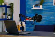 American Viewers TARGETED: Foreign Propaganda Infiltration Laptop and a microphone on a desk.