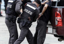 TOP TERROR BOSS SNATCHED – US Foils NYC Attack Police officers arresting a handcuffed person.