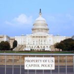 Shocking Leak Allegations Rock Congress View of the U.S. Capitol building with a security barrier in front
