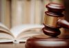 Raúl Castro Charged: Justice or Political Theater? A wooden gavel resting on a sound block with law books in the background