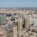 Aerial view of a sprawling urban city with high-rise buildings and green spaces