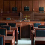 Texas Trial Without A Single Black Juror Empty courtroom with wooden furnishings and judges bench.