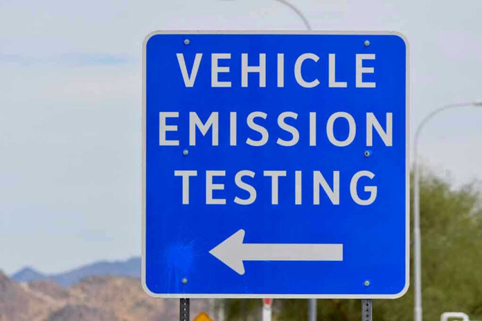 1481782967 Blue sign for vehicle emission testing direction.