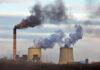 Trump Wields Wartime Law For Coal Industrial plant emitting black smoke into the sky.