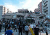 Cameras Roll As Mega Quake Hits People at a collapsed building after an earthquake.