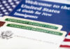 Permanent resident cards with welcome guide and flag.