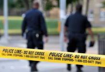 Reckless Crash, Then A Child Left Behind Police officers walking past caution tape at a crime scene