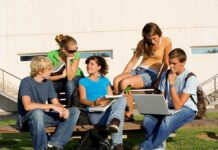 Berkeley Dorm Horror Sparks Campus Cover-Up? Group of students sitting on a bench outdoors, engaged in study and discussion