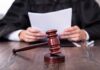 COVID Psychosis Defense Frees Child Killer A judge holding documents with a gavel in the foreground