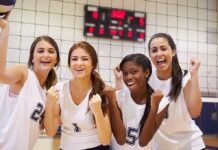 High-Stakes Ruling Rewrites Women’s Sports Four female volleyball players celebrating in a gymnasium