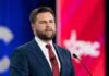 White House Moment, Unthinkable Backstory A man in a suit delivering a speech at a conference